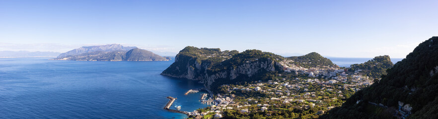 Fototapeta na wymiar Touristic Town on Capri Island in Bay of Naples, Italy. Sunny Blue Sky. Panorama