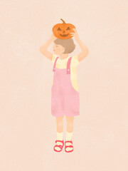 cute smiling little girl holding a Halloween pumpkin