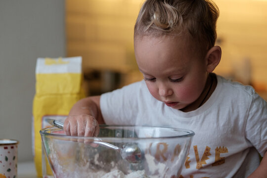 Busy Curious Little Boy Toddler Making Homemade Playdough, Playing With Flour While Cooking In Kitchen, Selective Focus. Sensory Play Activity For Kids