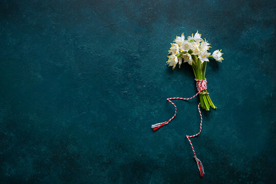 Fresh Beautiful Bouquet Of The First Spring Forest Snowdrops Flowers With Red And White Cord Martisor - Traditional Symbol Of The First Spring Day On Blue Background