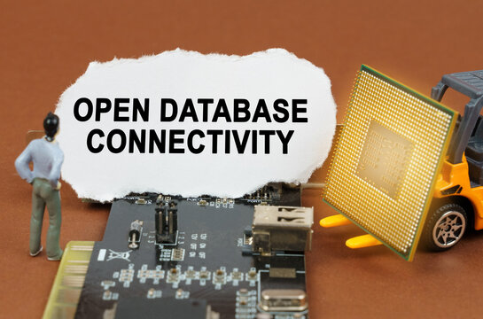 On the board with microcircuits lies a paper plate with the inscription - Open Database Connectivity