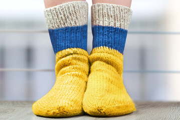 National flags of Ukraine on a pair wool knitted socks. Symbolizing  a fighting against war.