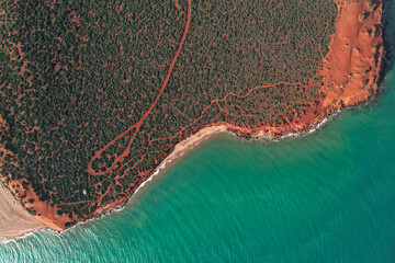 Cape Peron view from the sky. Aerial picture of orange land, long roads and the ocean in Shark Bay, Western Australia. Top down with a drone.