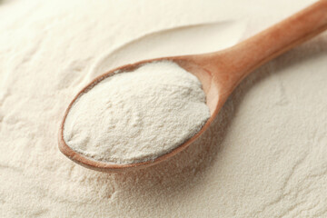 Wooden spoon on organic agar-agar powder, closeup