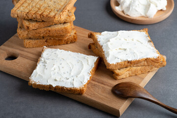 Bread with cottage cheese on a grey table