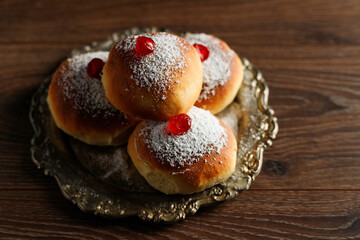 Jewish holiday Hanukkah with donuts and wooden dreidels (spinning top), chocolate coins. Top view