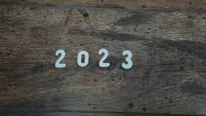 New year 2023 numbers on a wooden background