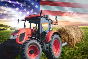 Fotobehang National agricultural industry concept - idyllic farm field with hay bales and tractor on on the background of the USA flag (mixed). © WDnet Studio