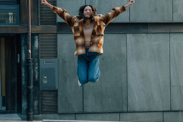 euphoric girl jumping happy on the street