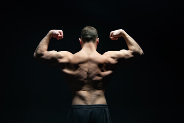 Fototapeta na wymiar bodybuilder with muscular back isolated on black background. muscular bodybuilder