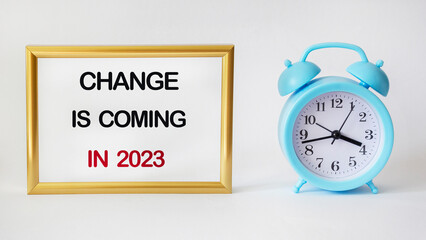 Changes are coming in 2023. Concept word Changes in 2023 in golden frame on white background with clock. Business and change in 2023 concept.