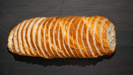 Top view of slices of white bread on wooden chopping board, panoramic shot