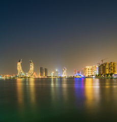 Lusail city on the beachfront lit up at night in Doha, Qatar