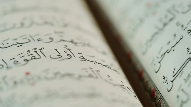 The Holy Quran Book, koran Chapter, flipping pages Close up Macro.
