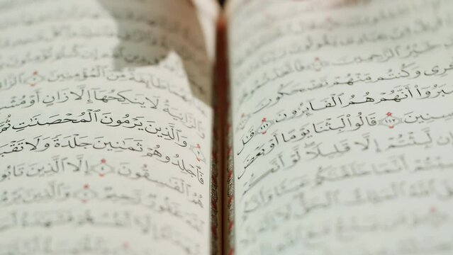 The Holy Quran Book, koran Chapter, flipping pages Close up Macro.