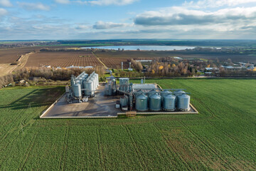 Fototapeta na wymiar aerial view of huge agro-industrial complex with silos and grain drying line