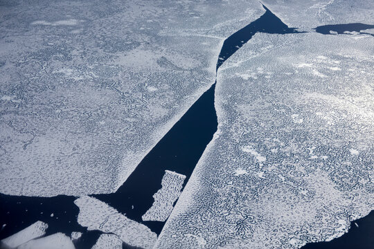 A large detached piece of sea ice breaks away from the main structure.; Greenland.