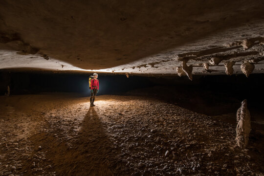 Researcher exploring stalagmites in a cave in Gunung Mulu National Park; Sarawak, Borneo, Malaysia