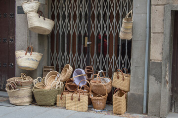 wicker baskets next to a shop in a street in Segovia. Spain