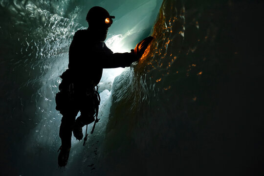 A cave explorer and glaciologist traverses through a tunnel below the surface of the Gornergletscher.