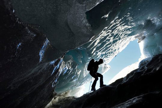 A cave explorer descending into a moulin on the Gorner Glacier.