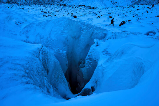 A cave explorer at a giant moulin, named None Stop, on the Gorner Glacier in Switzerland.