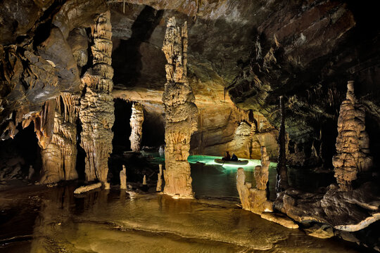 Explorers paddle on a lake inside Krizna jama, the Cross Cave.