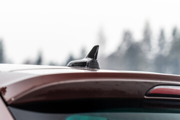 Modern car radio antenna. Shark fin antenna. Modern car roof.
