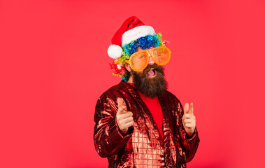 Funny man with beard. Winter holidays. Remember reason for season. Bearded man celebrate christmas. Christmas decorations. Party entertainment. Christmas spirit. Cheerful clown colorful hairstyle