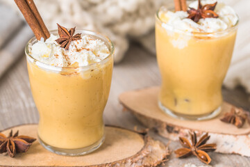 Two glasses of eggnogg with whipped cream and cinnamon. Auld Man's milk, Coquito or Creme de Vie or...