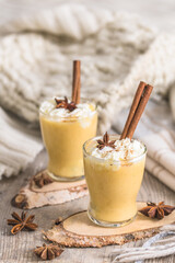 Two glasses of eggnogg with whipped cream and cinnamon. Auld Man's milk, Coquito or Creme de Vie or...