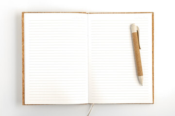 Opened notebook with pen on white background