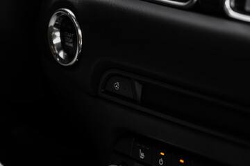 Obraz na płótnie Canvas Close up of car steering wheel heating control. Steering wheel heating button in the car.