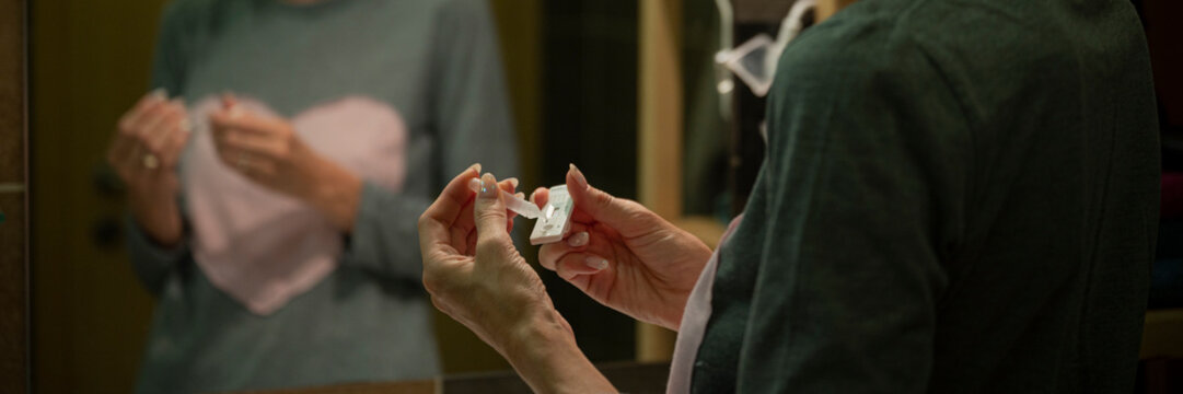 Female Hands Dripping Saline Testing Water On A Test Stick Of Coronavirus Home Test Kit