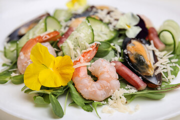 Plate of delicious salad with seafood, closeup view