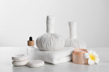 Fototapeta na wymiar Spa composition with care products on white marble table