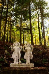 Fototapeta premium VISHNU AND LAKSHMI, stone sculpture in Humanics Sanctuary & Sculpture Park, fall in Ottawa, Canada