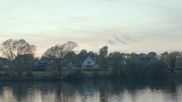 Image of lake and lakeside houses at sunset. Sunset landscapes.