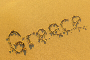 The inscription on the sandy beach Greece