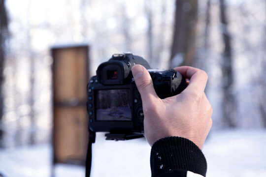 a man taking photo on the snow with  in winter