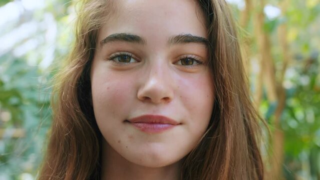 Girl, face or teenager in plant shop, garden center or greenhouse nursery in Canada education study or learning biology. Zoom, portrait or happy student and climate change goals or planet earth ideas