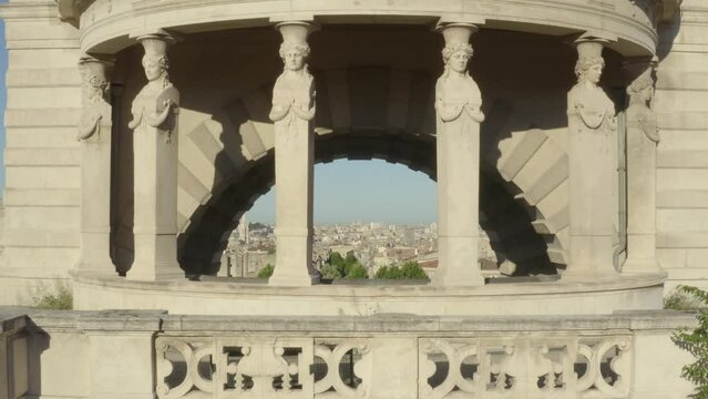 Aerial shot that passes through the Longchamps Palace and reveals the city of Marseille, in France