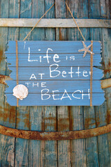 Wooden sign motivational quote. Summer vacation concept. Life is better on the beach
