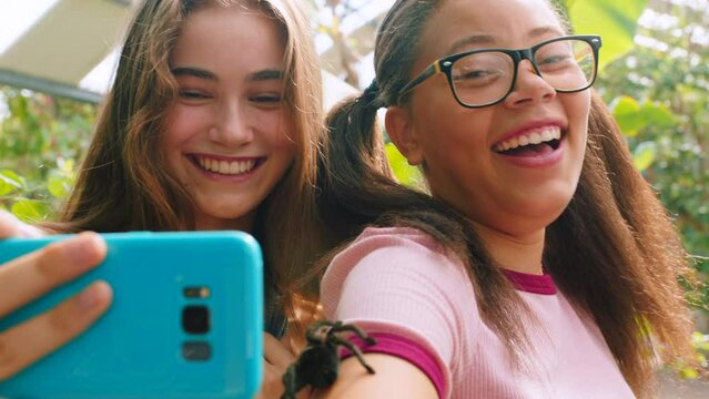 Tarantula, girls and friends with phone selfie outdoor with a smile, happiness and friendship. Happy, mobile and 5g wifi picture with technology for social media online with internet smiling