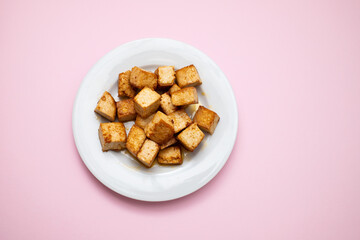 crispy deep stir fried tofu cubes on small dish