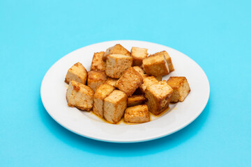 crispy deep stir fried tofu cubes on small dish