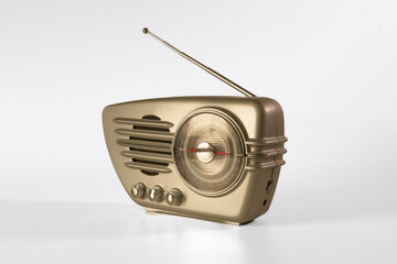 Retro radio bronze chrome color with antenna on white background