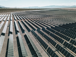 Renewable solar energy solar farm in the desert of southern Nevada on a dry lake bed gathering sun rays and photovoltaic energy to provide sustainable electricity to nearby Las Vegas and other areas