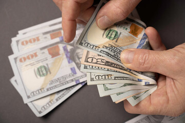 Money, US dollar bills background. Hands holding dollar bills