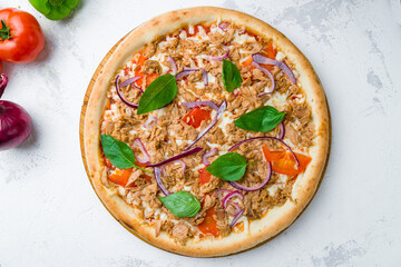 Pizza with tuna and red onion top view on concrete table